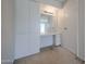 Built-in vanity with cabinets, drawers, mirror, and lighting in bedroom near doorway at 13618 N 98Th Ave # C, Sun City, AZ 85351