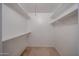 A walk-in closet boasts white walls and shelving, offering a simple, functional storage space at 13618 N 98Th Ave # C, Sun City, AZ 85351