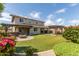 Expansive backyard with lush green grass, pergola, outdoor fireplace and blooming flower bushes, perfect for outdoor entertainment at 14674 W Pasadena Ave, Litchfield Park, AZ 85340