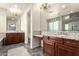 Luxury bathroom featuring dual vanities with granite countertops and elegant fixtures at 14674 W Pasadena Ave, Litchfield Park, AZ 85340