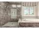 Elegant primary bathroom with a frameless glass shower, soaking tub, and stylish finishes at 14674 W Pasadena Ave, Litchfield Park, AZ 85340