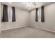 Bright, carpeted bedroom featuring neutral paint, a ceiling fan and plantation shutters at 14674 W Pasadena Ave, Litchfield Park, AZ 85340