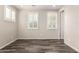 Empty bedroom highlighting tile flooring, bright windows, and neutral color scheme at 14674 W Pasadena Ave, Litchfield Park, AZ 85340