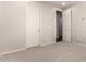 This bedroom features neutral paint, soft carpeting, and multiple doors and electrical outlets at 14674 W Pasadena Ave, Litchfield Park, AZ 85340