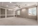 Spacious bedroom with custom paneled accent wall, tray ceiling, and bright natural light at 14674 W Pasadena Ave, Litchfield Park, AZ 85340