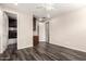 Guest bedroom featuring wood-look tile flooring, attached bath, and ceiling fan at 14674 W Pasadena Ave, Litchfield Park, AZ 85340