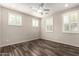 Bright and open bedroom with plantation shutters and sleek wood-look tile flooring at 14674 W Pasadena Ave, Litchfield Park, AZ 85340