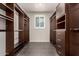 Large walk-in closet offering ample shelving and storage with a bright window at 14674 W Pasadena Ave, Litchfield Park, AZ 85340