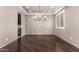 Elegant dining room with wood flooring, decorative wall, and a stylish chandelier, perfect for entertaining at 14674 W Pasadena Ave, Litchfield Park, AZ 85340
