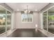 Bright dining room with views to the backyard through large windows and sliding glass doors at 14674 W Pasadena Ave, Litchfield Park, AZ 85340
