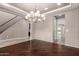Elegant dining room with hardwood floors, a stylish chandelier, and open access to other living spaces at 14674 W Pasadena Ave, Litchfield Park, AZ 85340