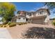 Inviting two-story home boasting a brick driveway, spacious two-car garage, and elegant architectural details at 14674 W Pasadena Ave, Litchfield Park, AZ 85340