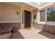 Inviting front entry with decorative stone accents, a charming wreath, and a welcoming doormat at 14674 W Pasadena Ave, Litchfield Park, AZ 85340