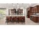 Modern kitchen with a large center island, stainless steel appliances, and pendant lighting at 14674 W Pasadena Ave, Litchfield Park, AZ 85340
