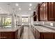 Gourmet kitchen boasts a large island, stainless steel appliances, and granite countertops at 14674 W Pasadena Ave, Litchfield Park, AZ 85340