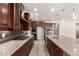 Modern kitchen with an island, granite countertops, stainless steel appliances, and plenty of storage at 14674 W Pasadena Ave, Litchfield Park, AZ 85340