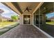 Large, brick patio with backyard views with greenery, firepit, and comfortable lounge area at 14674 W Pasadena Ave, Litchfield Park, AZ 85340