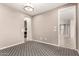 Empty room featuring neutral paint and patterned carpet leading to other areas of the house at 14674 W Pasadena Ave, Litchfield Park, AZ 85340