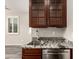 The wet bar features granite counters, dark wood cabinets and modern faucet fixtures at 14674 W Pasadena Ave, Litchfield Park, AZ 85340