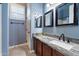 Well-lit bathroom with granite countertops, vanity with a modern sink, and a stylish mirror at 1641 N Channing --, Mesa, AZ 85207