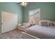 Bedroom with white furniture, hardwood floors, a chair, and shutters on the window at 1641 N Channing --, Mesa, AZ 85207