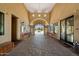 Elegant clubhouse entry showcasing a decorative arched doorway, seating and desert views for a grand arrival at 1641 N Channing --, Mesa, AZ 85207