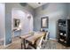 Open dining room with hardwood floors, rustic table, decorative mirrors, and views into other living spaces at 1641 N Channing --, Mesa, AZ 85207