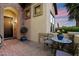 Cozy front porch with brick flooring, seating, potted plants, and an inviting entrance at 1641 N Channing --, Mesa, AZ 85207