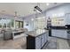 Spacious kitchen featuring an island, blue cabinets, stainless steel appliances, and an open layout to the living area at 1641 N Channing --, Mesa, AZ 85207