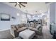 Bright, open-concept living area flows into kitchen, complete with a large sectional, neutral decor, and modern finishes at 1641 N Channing --, Mesa, AZ 85207