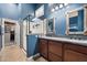 The primary bathroom features a double sink vanity, walk-in shower, and access to a large custom closet system at 1641 N Channing --, Mesa, AZ 85207