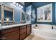 Spacious main bathroom with dual sinks, granite countertops, soaking tub, and bright lighting at 1641 N Channing --, Mesa, AZ 85207
