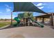 Community playground featuring slides, climbing structures and shade canopies on a cushioned surface at 1641 N Channing --, Mesa, AZ 85207