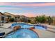 Backyard pool and spa with rock accents, lush landscaping, and stunning sunset views at 1641 N Channing --, Mesa, AZ 85207