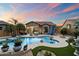 Beautiful backyard pool with seating, fire pit, and palm trees, perfect for entertaining on warm evenings at 1641 N Channing --, Mesa, AZ 85207