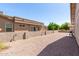 The backyard features a textured wall, rock landscaping, and is perfect for entertaining guests at 1703 Leisure World --, Mesa, AZ 85206