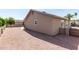 Gravel filled backyard with a view of the home's exterior and fencing at 1703 Leisure World --, Mesa, AZ 85206