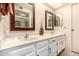Bright bathroom featuring a double vanity with white cabinets, framed mirrors, and a glass-enclosed shower at 1703 Leisure World --, Mesa, AZ 85206