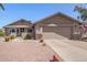 Charming single-story home featuring a well-maintained yard with desert landscaping and a two-car garage at 1703 Leisure World --, Mesa, AZ 85206