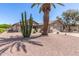 Charming single-story home featuring a well-maintained yard with desert landscaping and a two-car garage at 1703 Leisure World --, Mesa, AZ 85206
