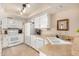 Bright kitchen featuring white cabinets, matching appliances, and a practical sink, completed with neutral countertops and tile floor at 1703 Leisure World --, Mesa, AZ 85206
