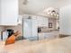 Well-lit kitchen boasts white appliances and cabinetry, paired with neutral countertops and tile floors for a clean aesthetic at 1703 Leisure World --, Mesa, AZ 85206
