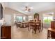 Bright and spacious living room with dining area featuring tile floors, neutral paint, and ample natural light at 1703 Leisure World --, Mesa, AZ 85206