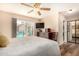 Light-filled main bedroom includes a ceiling fan, dresser, closet, and access to a private outdoor space through a sliding door at 1703 Leisure World --, Mesa, AZ 85206