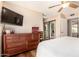 This well-lit main bedroom features a ceiling fan, neutral walls, a dresser, and an ensuite bath at 1703 Leisure World --, Mesa, AZ 85206