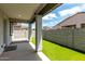 Backyard offers a covered patio, artificial turf lawn, and privacy fencing, ideal for relaxation and entertainment at 17437 W Via De Luna Dr, Surprise, AZ 85387