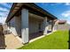 Backyard features a covered patio, artificial turf lawn, and modern exterior at 17437 W Via De Luna Dr, Surprise, AZ 85387