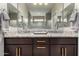 Bathroom features double sinks, granite counters, and dark wood cabinets at 17437 W Via De Luna Dr, Surprise, AZ 85387