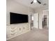 Spacious bedroom with large dresser, ceiling fan, and easy access to the bathroom and closet at 17437 W Via De Luna Dr, Surprise, AZ 85387