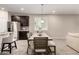 Dining area with a wood table and dark kitchen cabinetry in the background at 17437 W Via De Luna Dr, Surprise, AZ 85387
